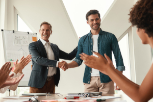 image of business associates shaking hands at a meeting.